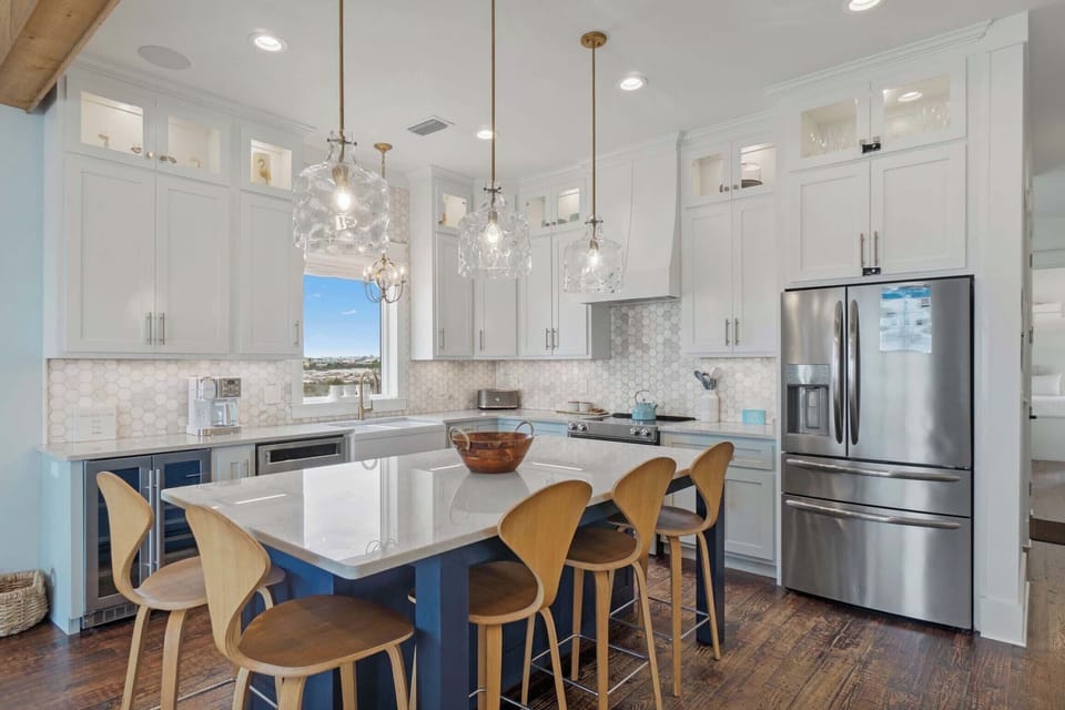 Bright coastal kitchen with spacious island and modern appliances for easy meals.