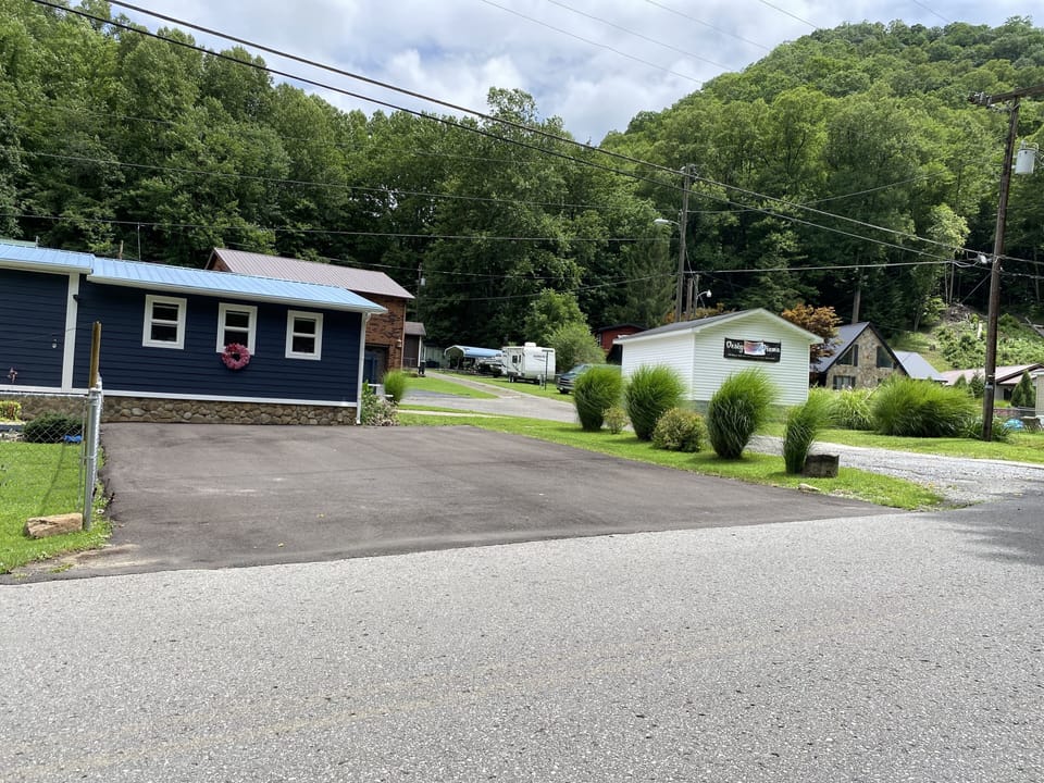 Driveway paved and fenced in front yard 