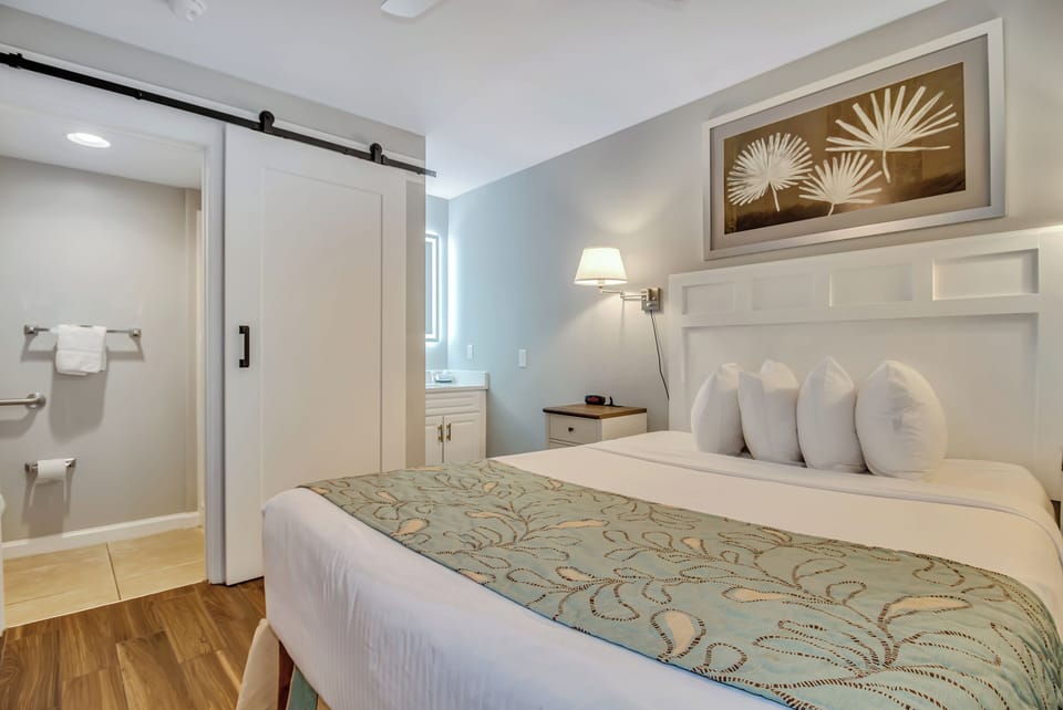 Sink into your plush bed with soft pillows and coastal artwork creating a peaceful retreat for your restful nights.