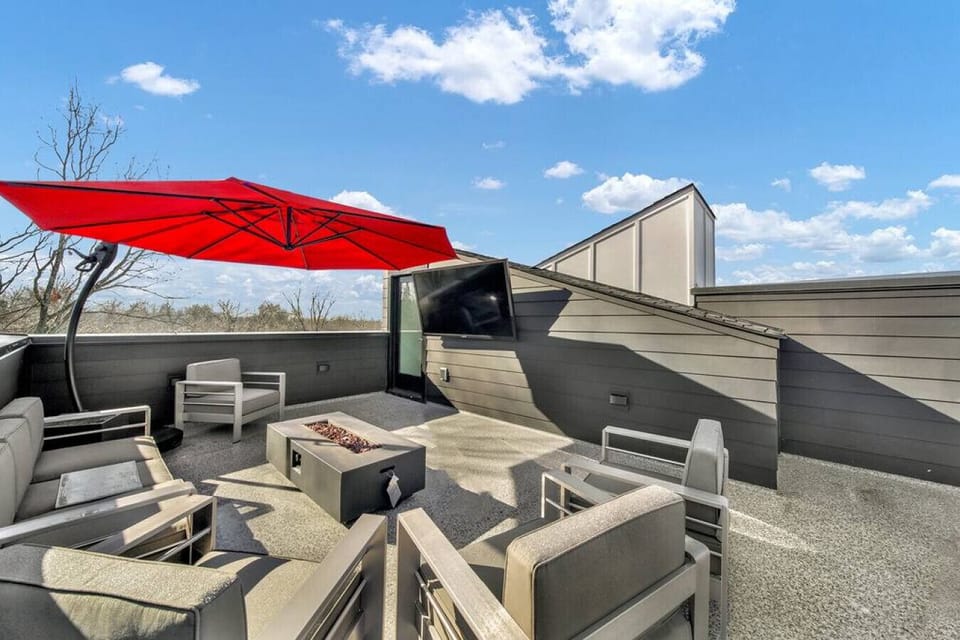 Stunning aerial shot of the private rooftop with city skyline views, 70” HDTV, fire pit, outdoor furniture seating, BBQ grill and bar. What more could you want?!