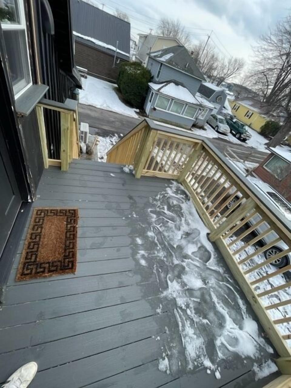 Large deck in warmer weather there is a table and chairs outside