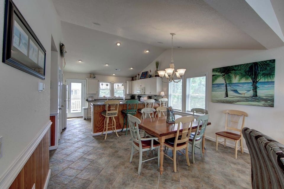 Dining and kitchen - This open concept floor plan  offers a large dining table and bright kitchen.