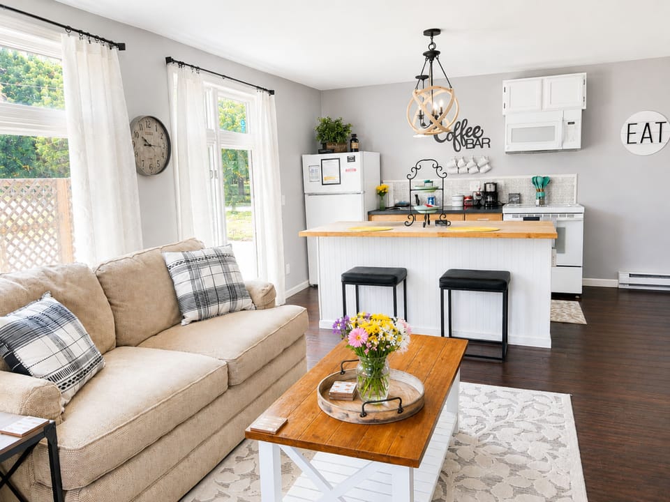 Bright open living space with breakfast bar and charming coffee station