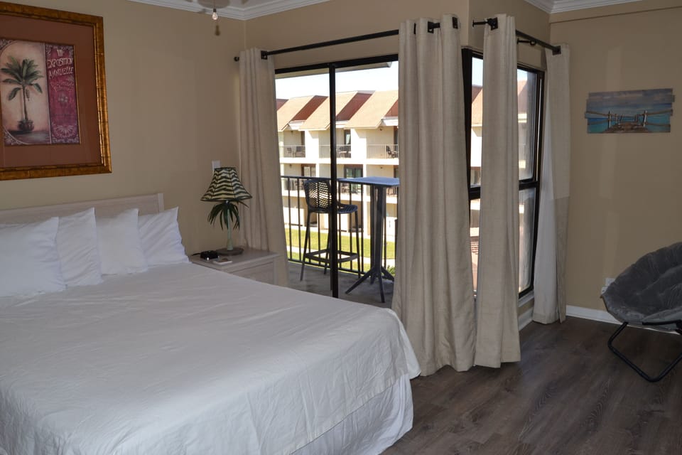 Master bedroom with private balcony.  Super comfortable, queen size bed.