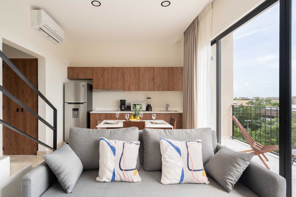 Sofa bed, living room, AC, ceiling fan, balcony.
