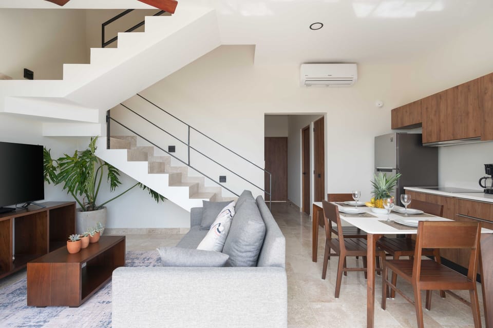 Living room, sofa bed, AC, Ceiling fan, Smart TV.