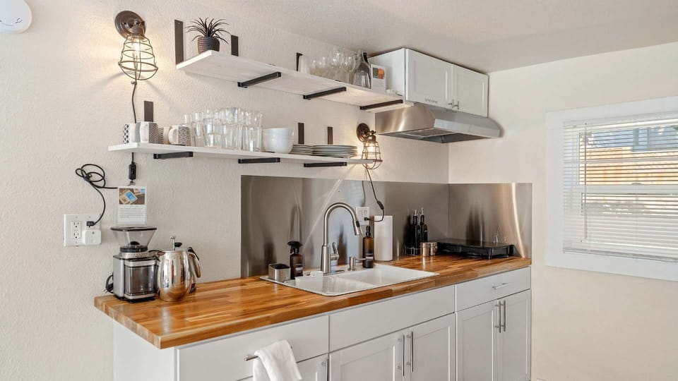 The kitchen has a sleek minimalist vibe, yet is fully stocked. Listen to some music and make a meal together. There is a microwave and toaster oven to add to your convenience. A full oven with stovetop and a refrigerator.