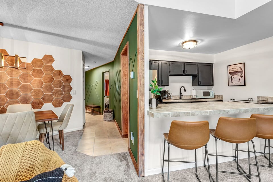 Modern comfort with mid-century flair—an open layout designed for cooking, relaxing, and gearing up for adventure together. 🏔️🍷