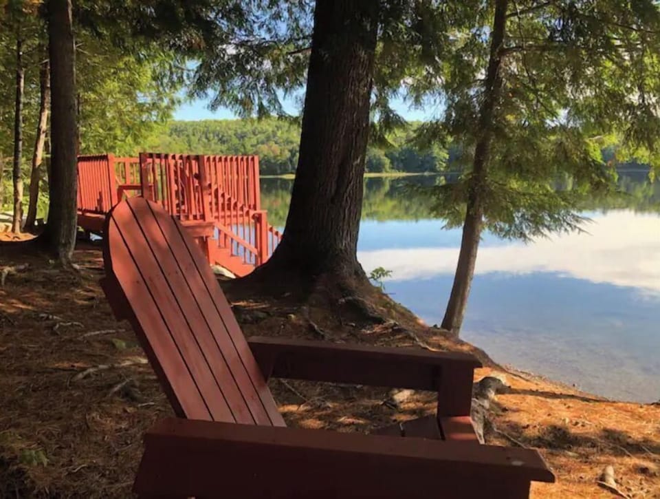 Looking to left from Adirondack chair toward lakeside deck and stairs to water.