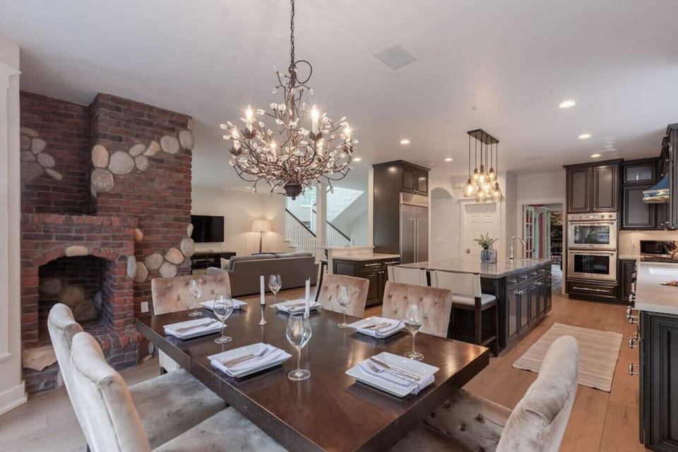 The dining area is laid out for a diner party, open to the kitchen and living area.