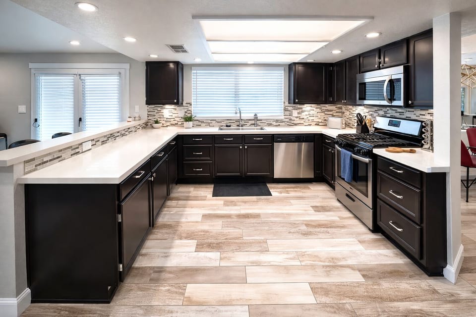 Modern U-shaped kitchen with quartz tops and stainless appliances