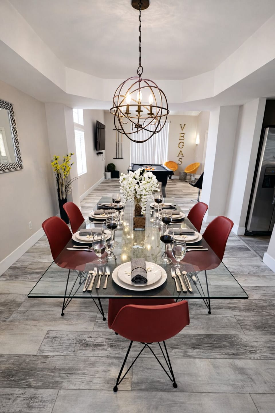 Modern dining for 8, chic lighting, open to TV lounge and pool table