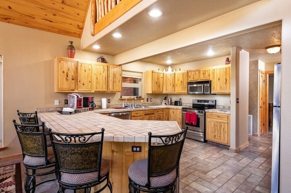 The kitchen with all stainless appliances has plenty of room to share meal prep