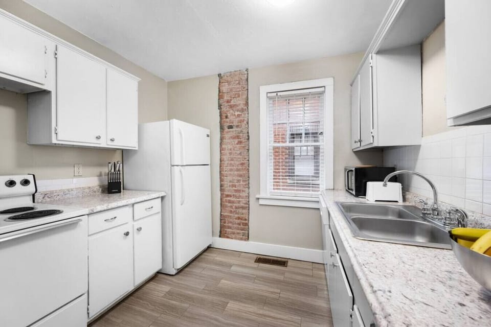 The kitchen with full-size refrigerator, microwave oven, toaster, and cooking. range for any meal prep needs.