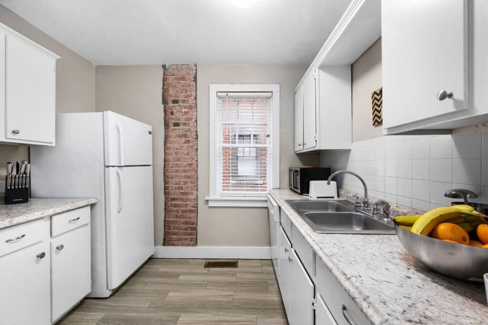 The kitchen with full-size refrigerator, microwave oven, toaster, and cooking. range for any meal prep needs.