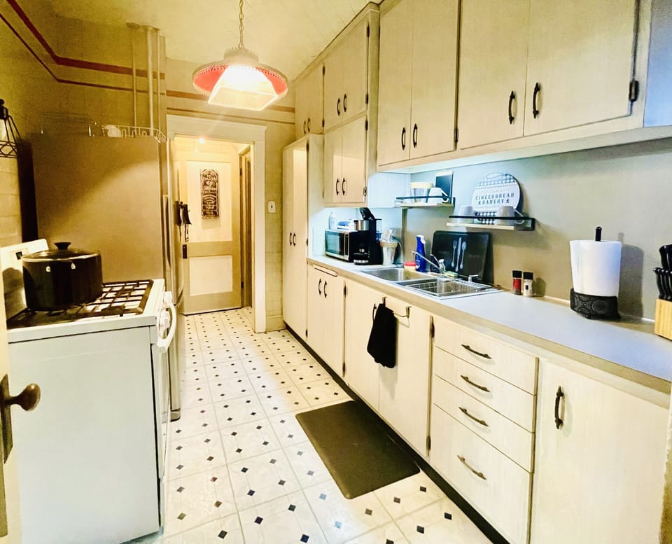 1st Fl Galley style kitchen w/ stainless fridge, gas stove/oven lots of storage