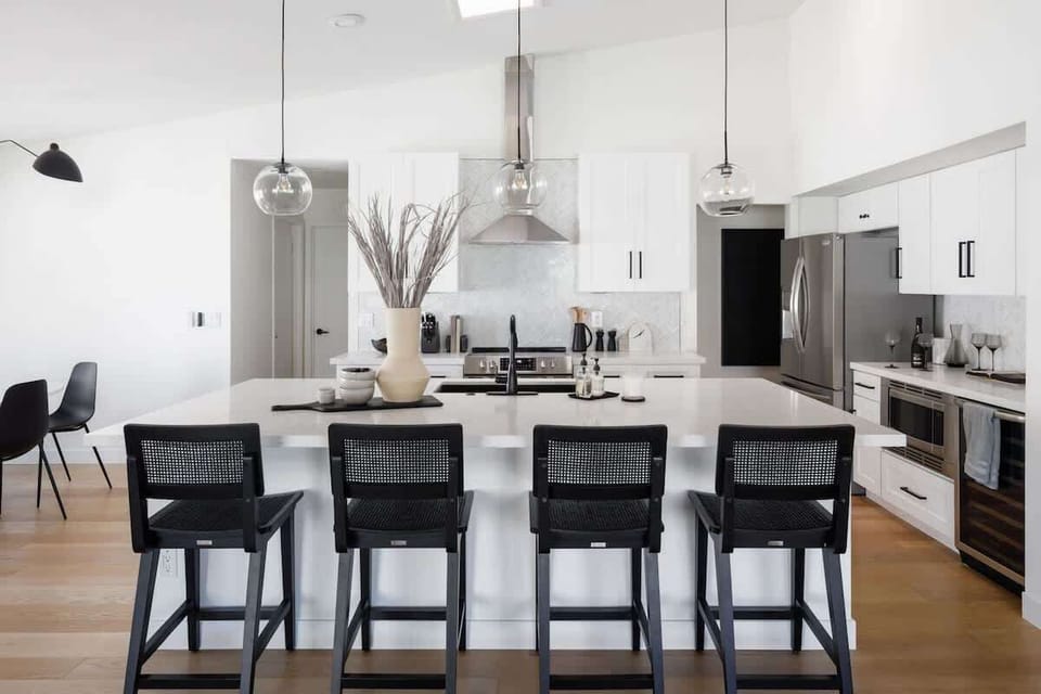 Open concept kitchen with stainless steel appliances, breakfast bar island seating, tons of natural light, and fully stocked with your basic cooking essentials.