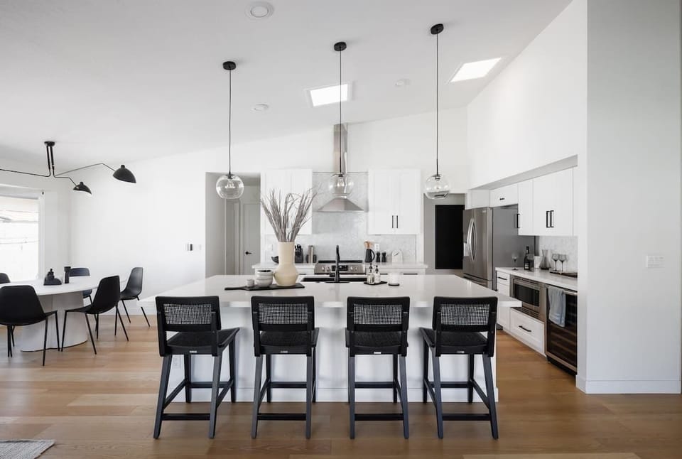 Open concept kitchen with stainless steel appliances, breakfast bar island seating, tons of natural light, and fully stocked with your basic cooking essentials.