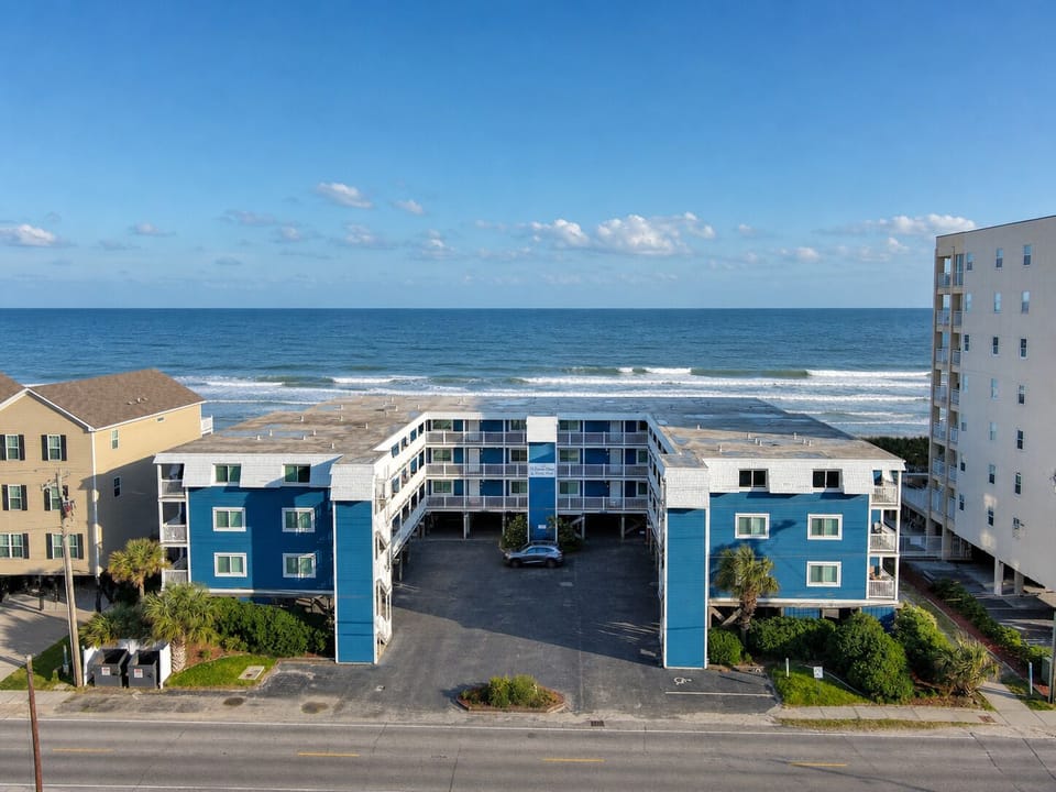 Oceanfront building with pool deck and on-site covered (underneath) parking