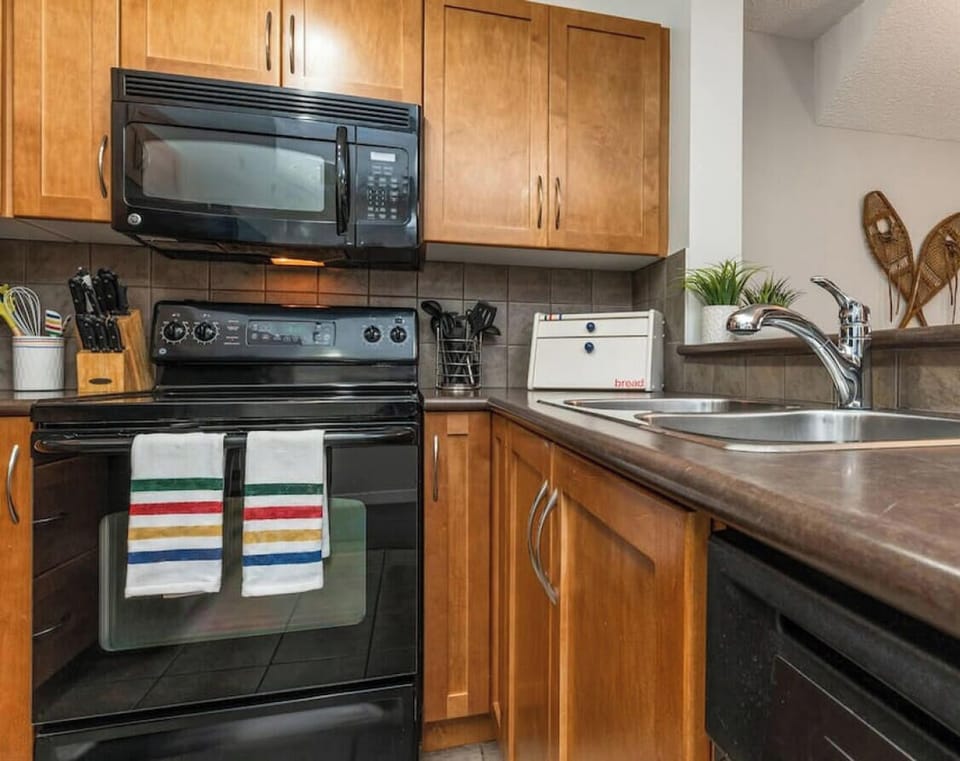 Full kitchen with a drip coffee machine, ground coffee, tea, sugar and basic condiments (ketchup, mustard and relish.)