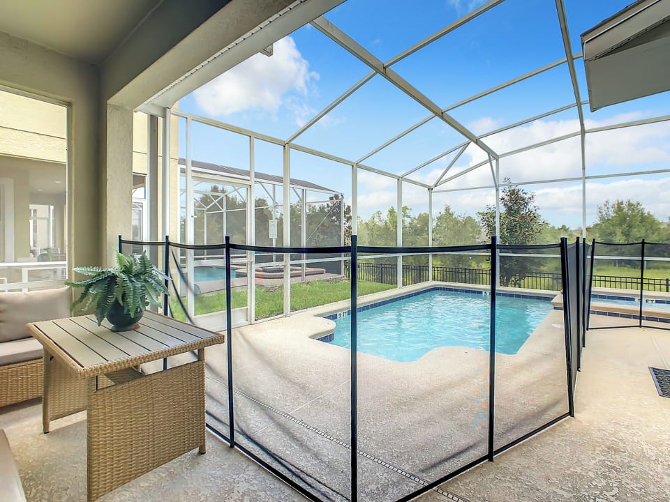 Relax by the private screened pool with scenic views and plenty of sunshine.
