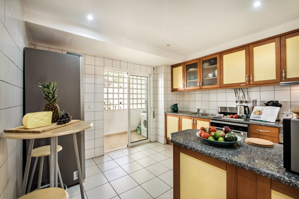 Kitchen and a peek of outdoor area with washing machine