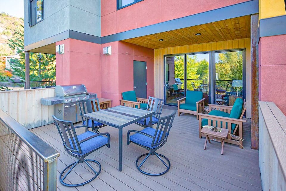 Main floor deck with BBQ and table for outdoor dining.