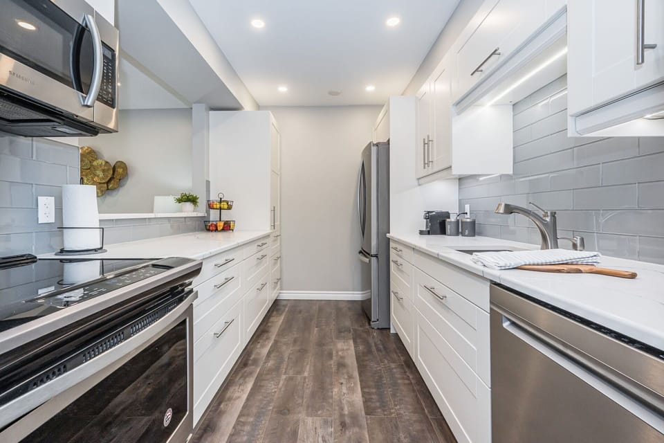 Kitchen with stainless steel appliances and quartz countertops
