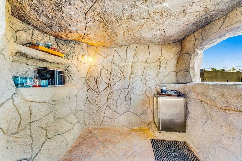 Inside of grotto bar complete with mini fridge, ice maker, glassware