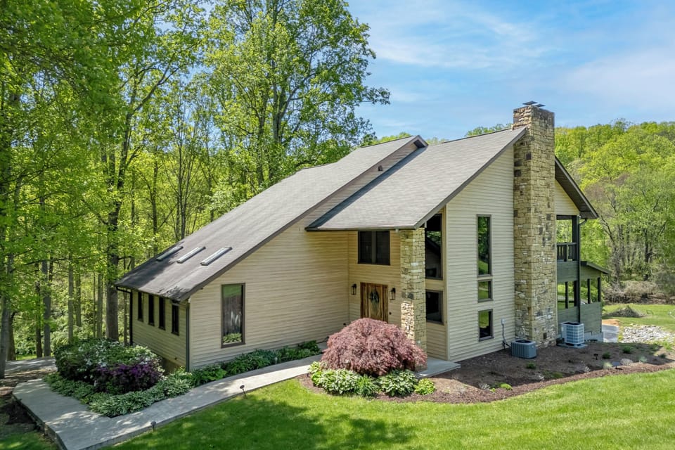 Wake to birdsong at this private creekside retreat with stone fireplace, 