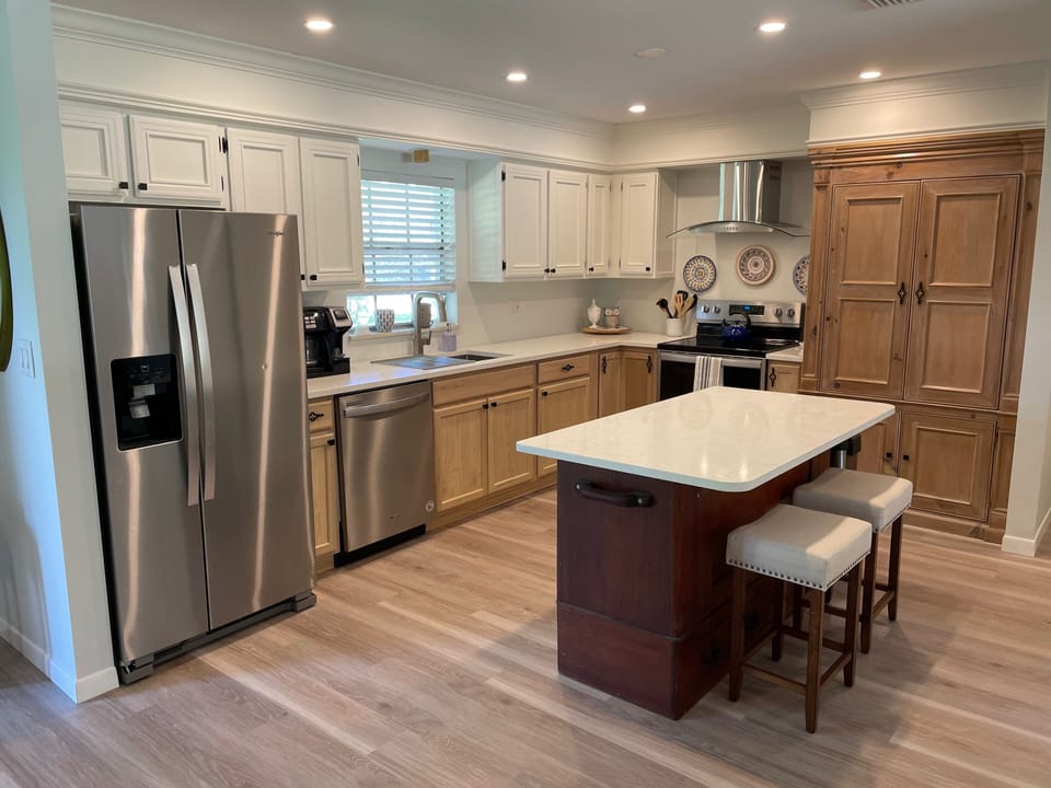 Large kitchen with stainless steel appliances and island with seating