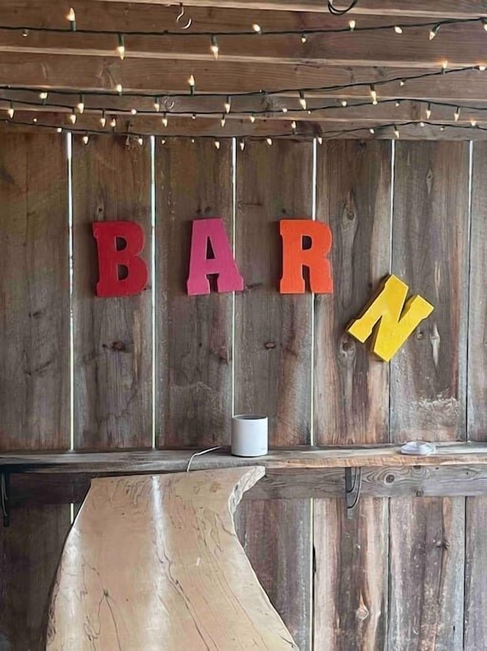 The open “BARn” has a bar countertop, dart board, hook and ring game, hammock, strong wifi.  At night it is lit by Christmas lights on the interior and tiki lights on the exterior.  