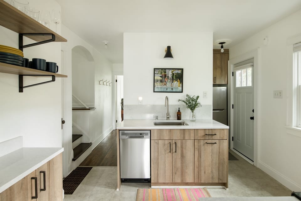 Custom cabinets, beautiful quartz countertops in the newly designed kitchen.