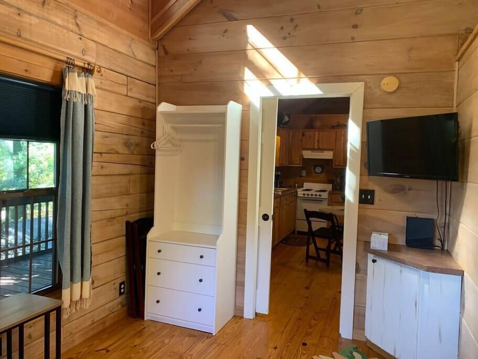 2nd bedroom closet and storage area with TV and pocket door for privacy