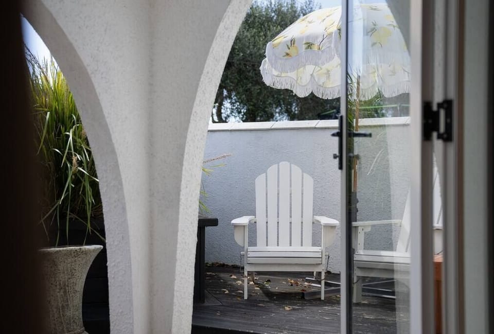 A sunny reading nook with cape cod chairs in the private courtyard.