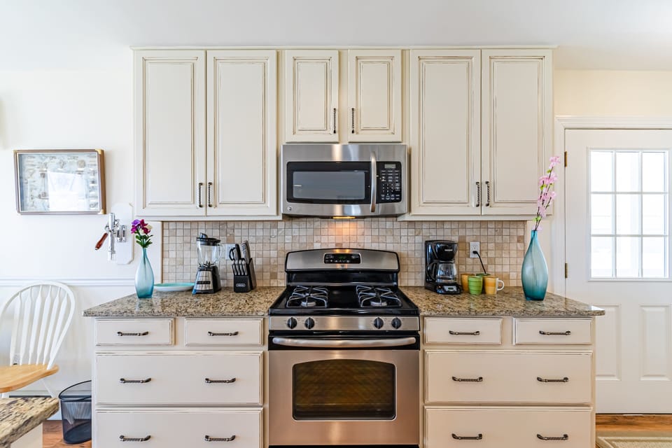 Gas range, oven, microwave, and fully stocked (dishes, glassware, pots, pans)