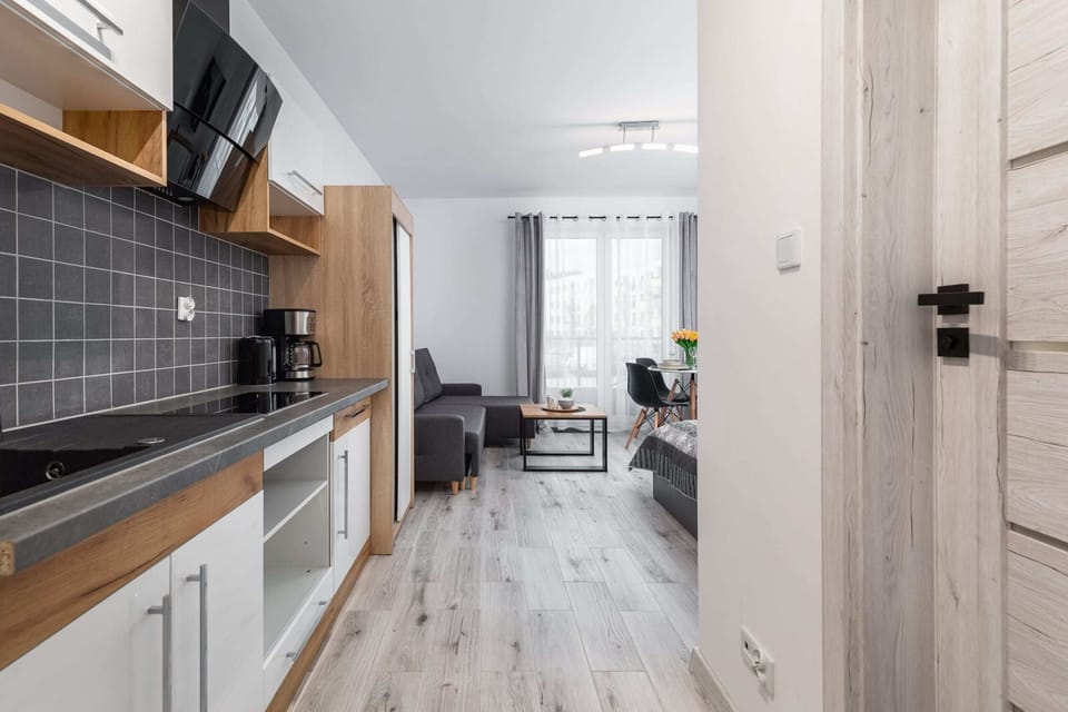 Kitchenette with kettle and refrigerator. 