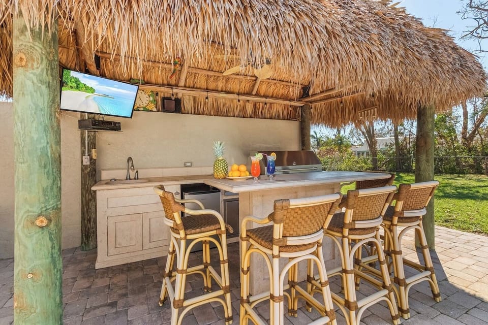 Sip on a cocktail at the tiki bar while catching your favorite sports game—your ultimate relaxation spot awaits!