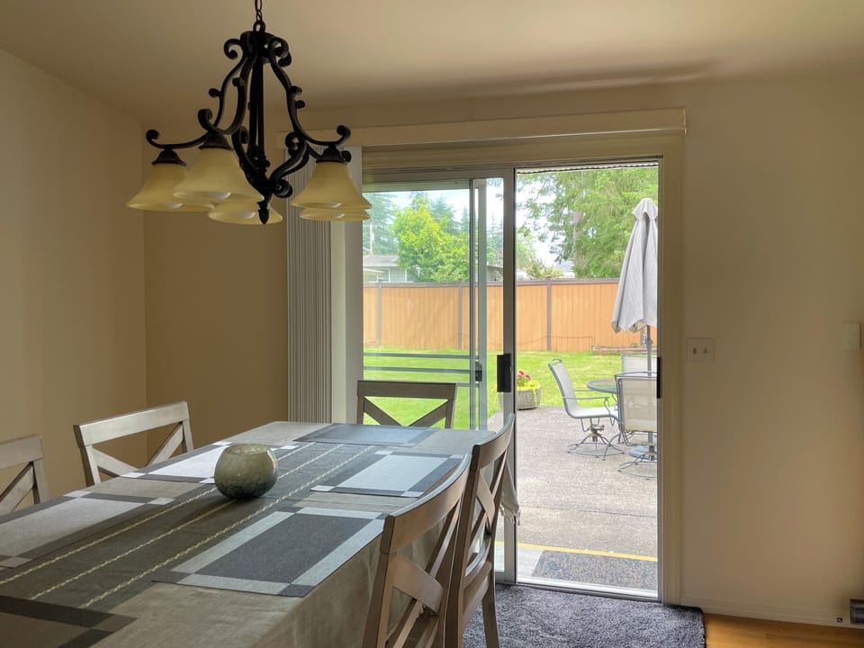 Dining area opens to spacious backyard.
