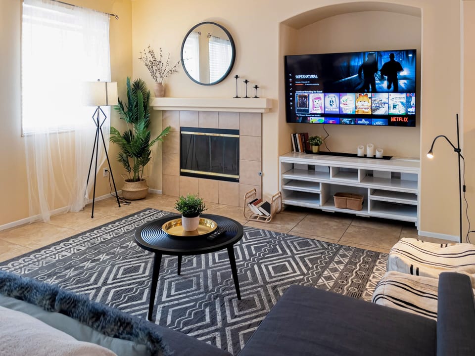 Our stylish & spacious living room comes with 2 bean bags, couch, & 65'' 4K HDTV