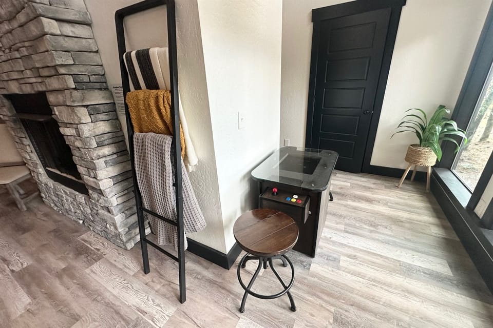Classic vibes with a mini arcade game, warm stone fireplace, and chill-out spot. Perfect for winding down after adventure-packed days.