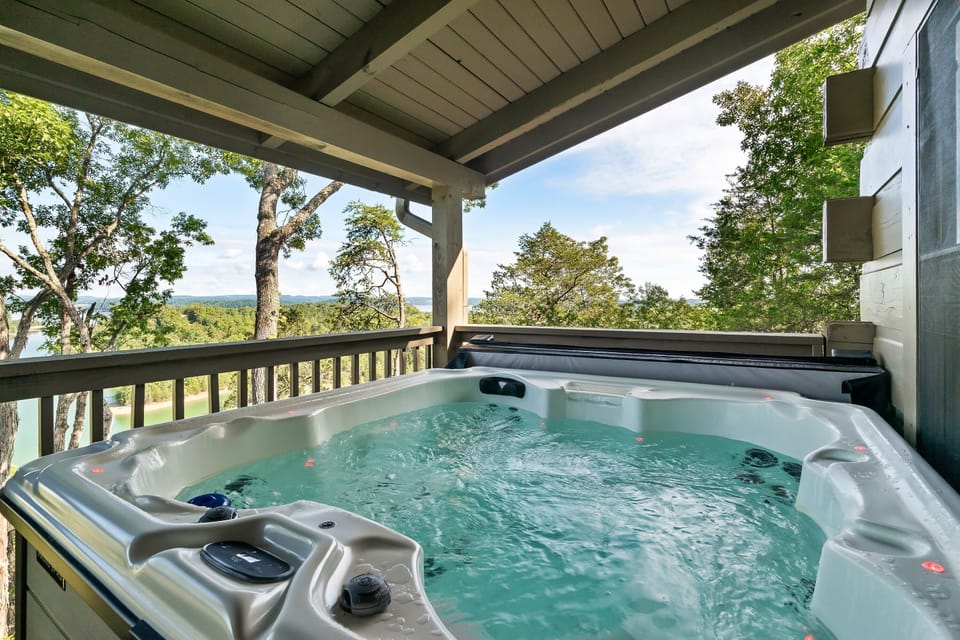 Relax in the private hot tub with panoramic Douglas Lake views