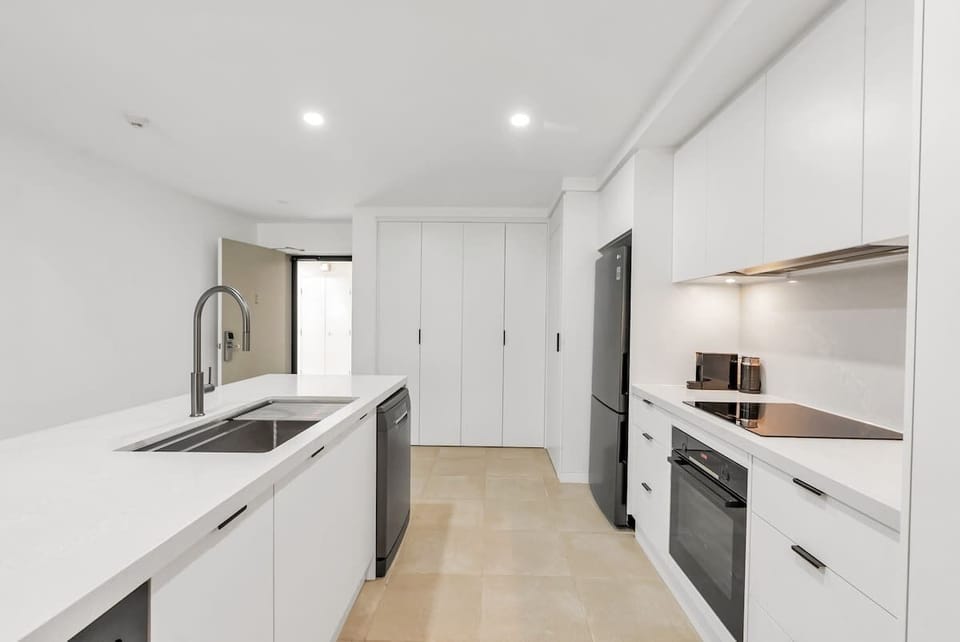 Step into the open-plan kitchen. This space invites you to create delicious meals while enjoying the company of family and friends.