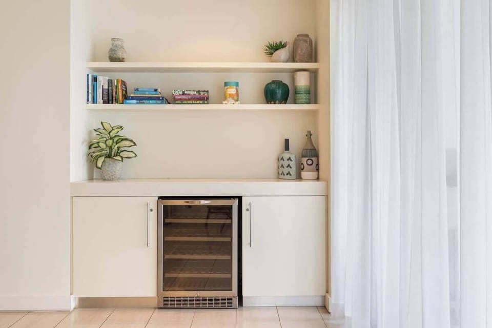 A wet bar makes it easy to test your mixology skills, with wine fridge to store drinks.