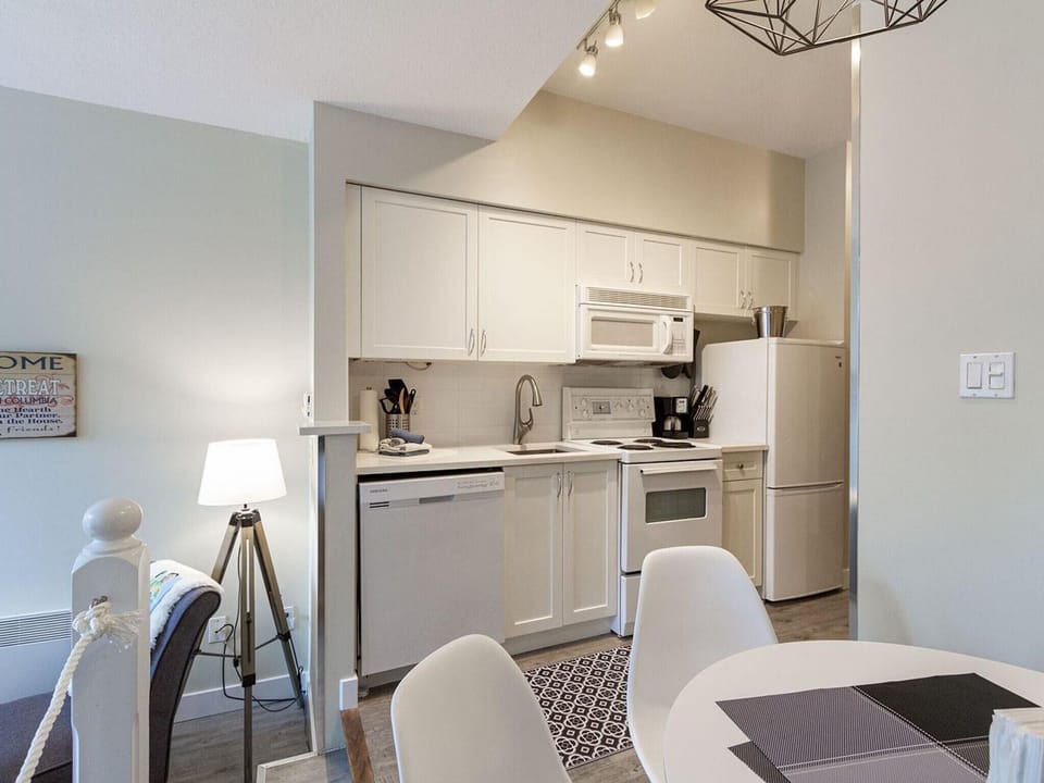Full kitchen with separate dining space, D/W, fridge and stove/oven