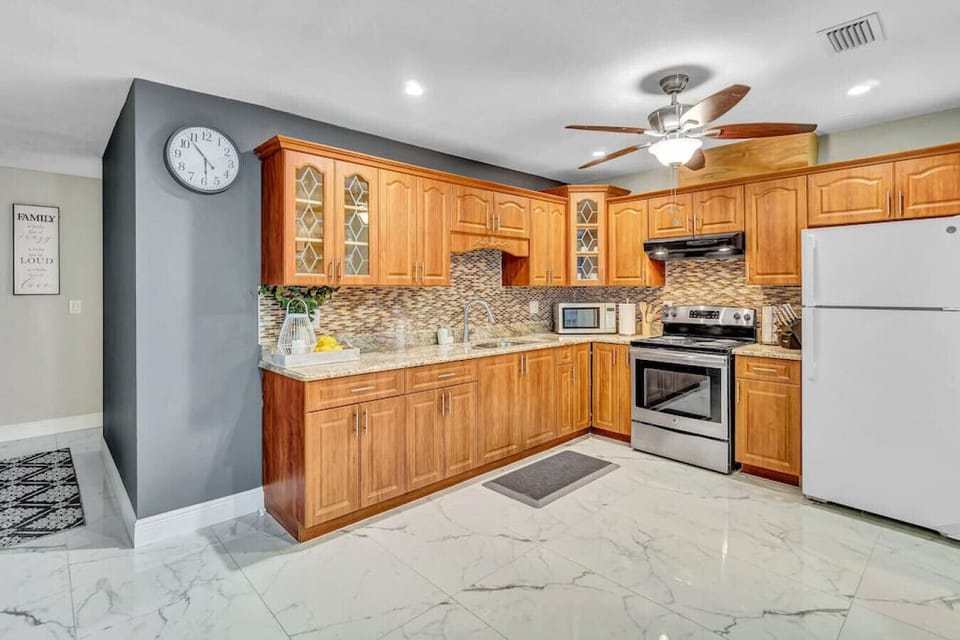 Stainless steel, sleek countertops, and good vibes - this kitchen is ready to cook up something delicious (and maybe a little bit fancy).