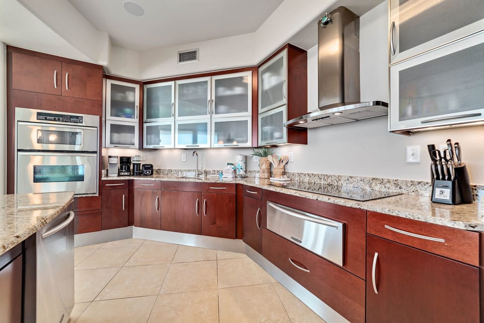 This well-designed kitchen boasts rich wood cabinetry, granite countertops, and stainless steel accents. The open layout ensures a seamless transition to the living and dining areas, creating a perfect space for gatherings.