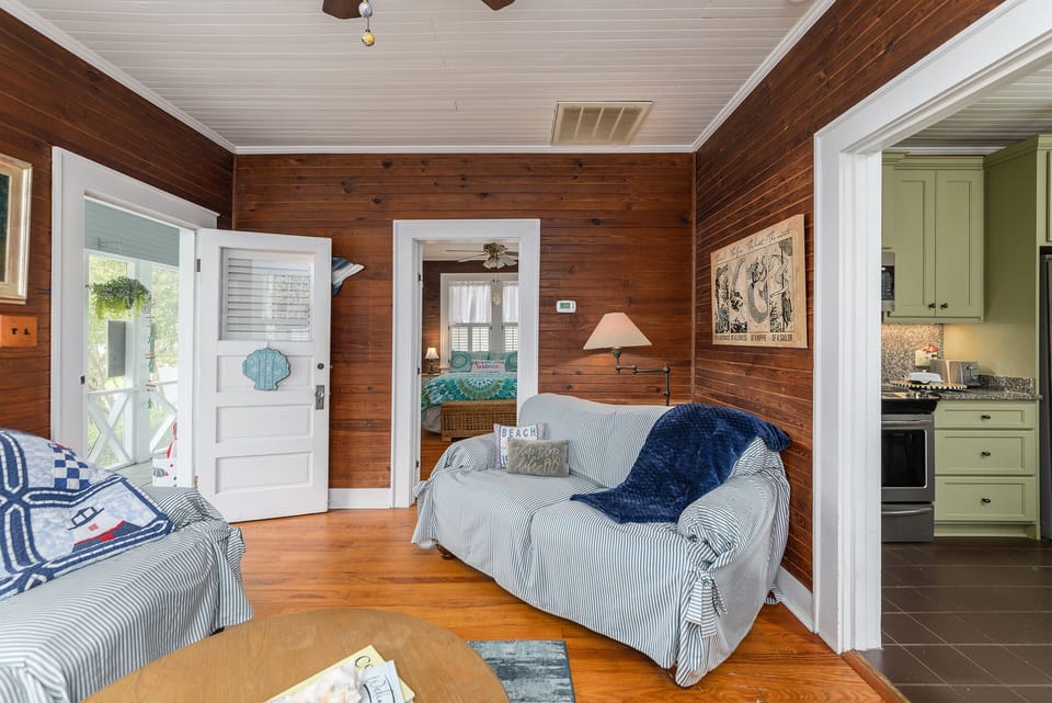 Living room with exit to the screen porch and entrance to one of the bedrooms.  Access into your marvelous  kitchen!