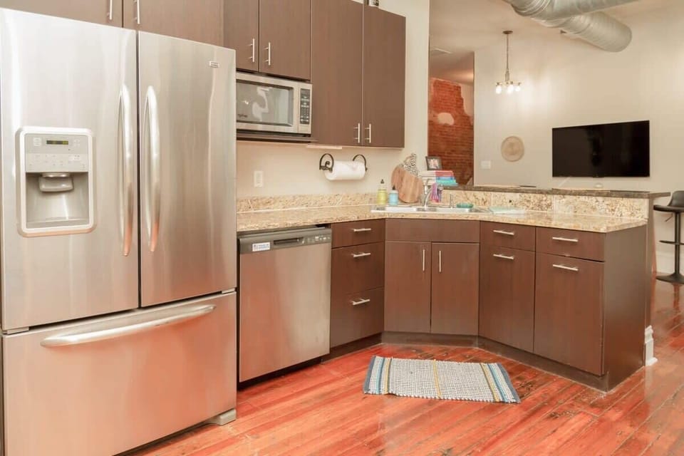 Fully equipped kitchen with stainless steel appliances and plenty of counter space for cooking at home. #OpenSpace
