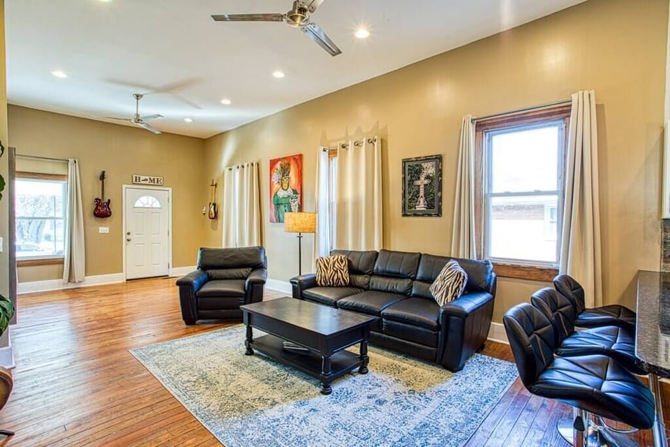Leather couches, stainless steel ceiling fans, bright and open. 
